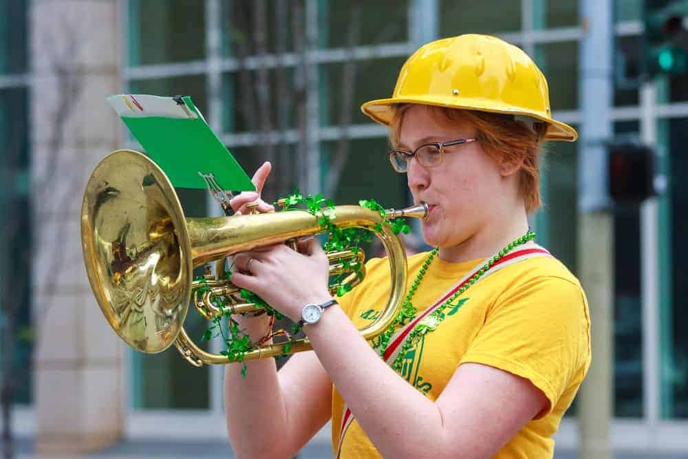 Woman playing a saxhorn.