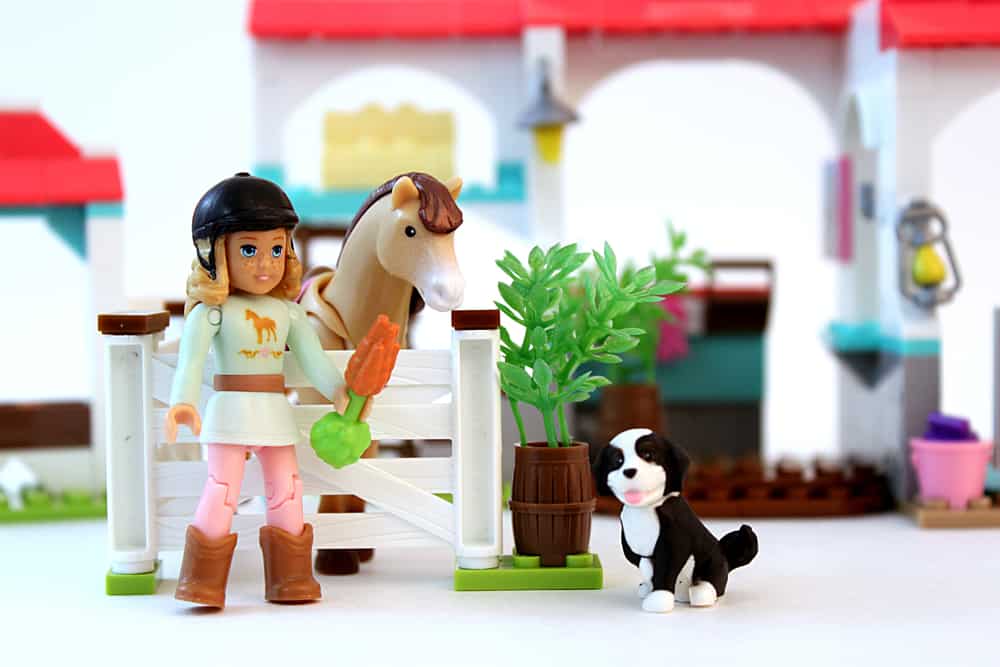 This is a close look at a Mega Construx toys with a girl, a dog and a horse.