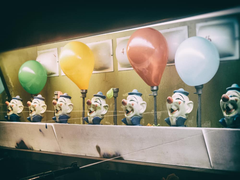 This is a close look at a carnival game with balloons.