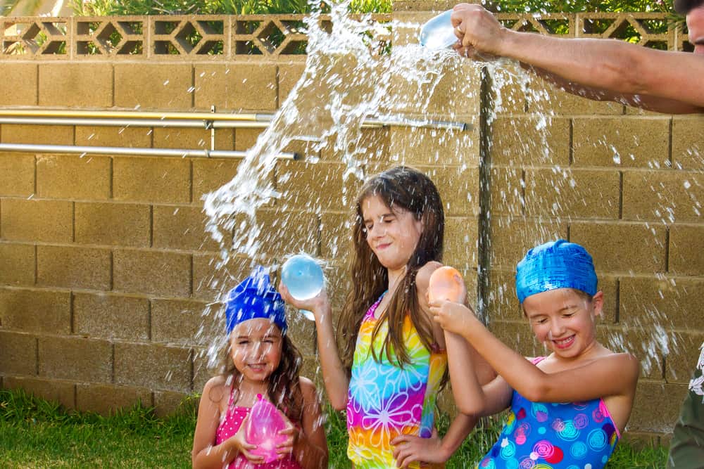 Kids playing with water balloons.
