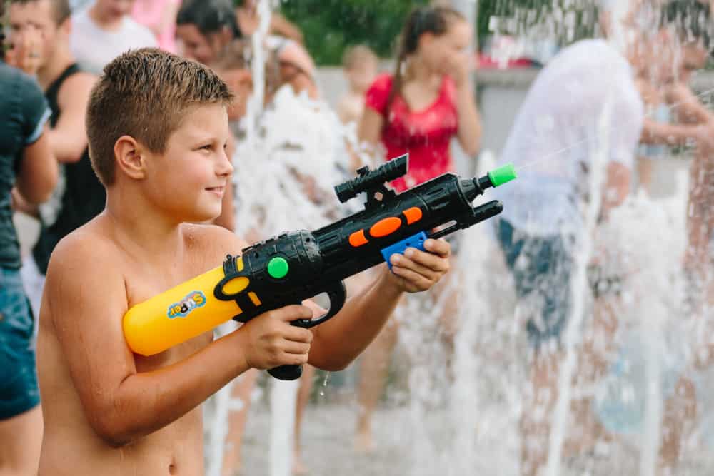 This is a kid playing with a squirt gun.