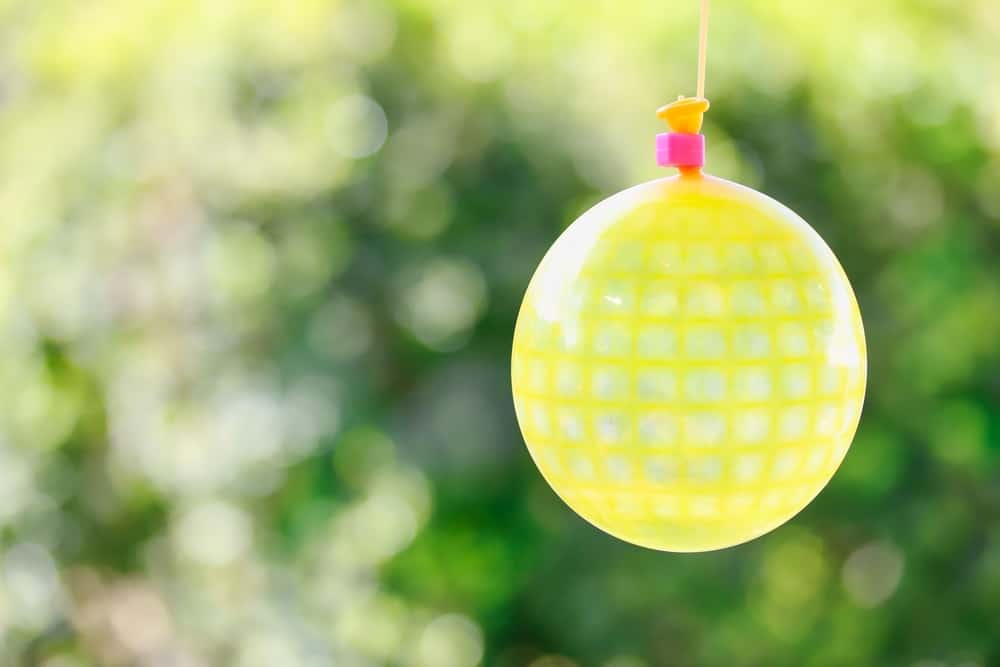 This is a close look at a yellow patterned water balloon pinata.