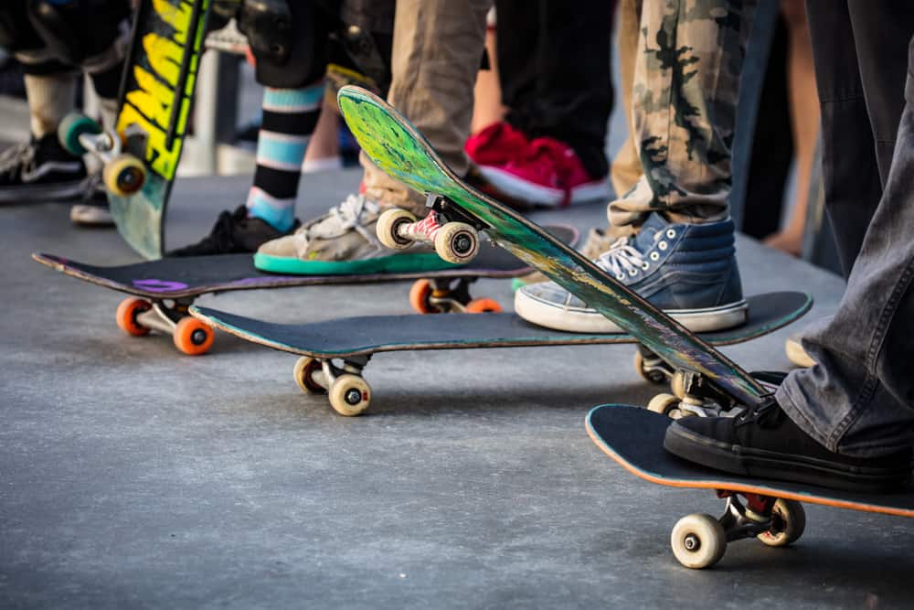 A close look at a row of skateboarders getting ready.