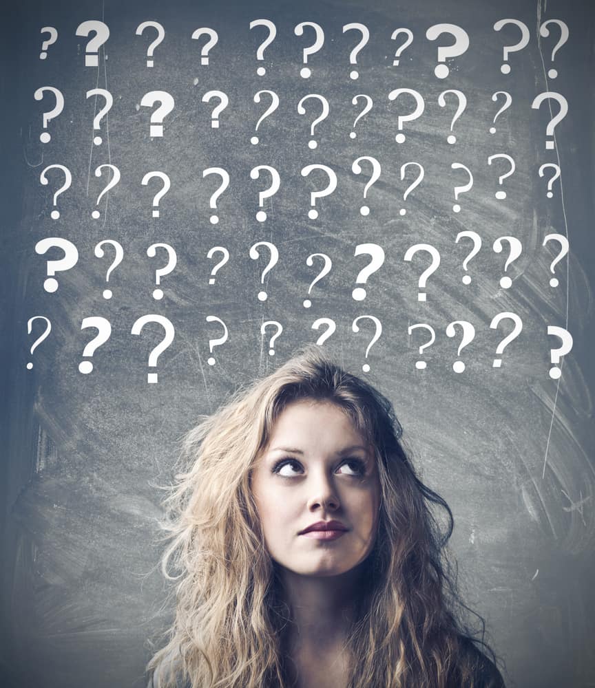 250 Best Would You Rather Questions for Teens 11 A confused teen girl with various question marks above her head.