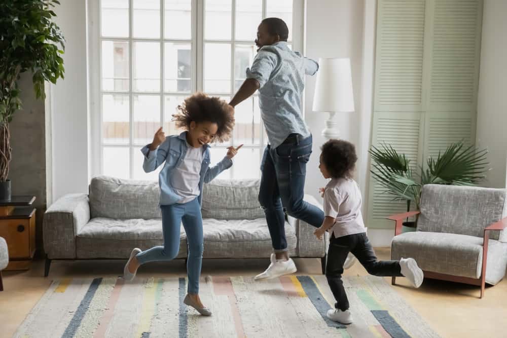200 Best Indoor Activities for Kids 2 A family dancing in the living room.