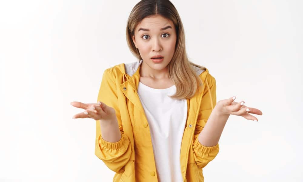 250 Best Would You Rather Questions for Teens 4 A teen girl shrugging her shoulders.