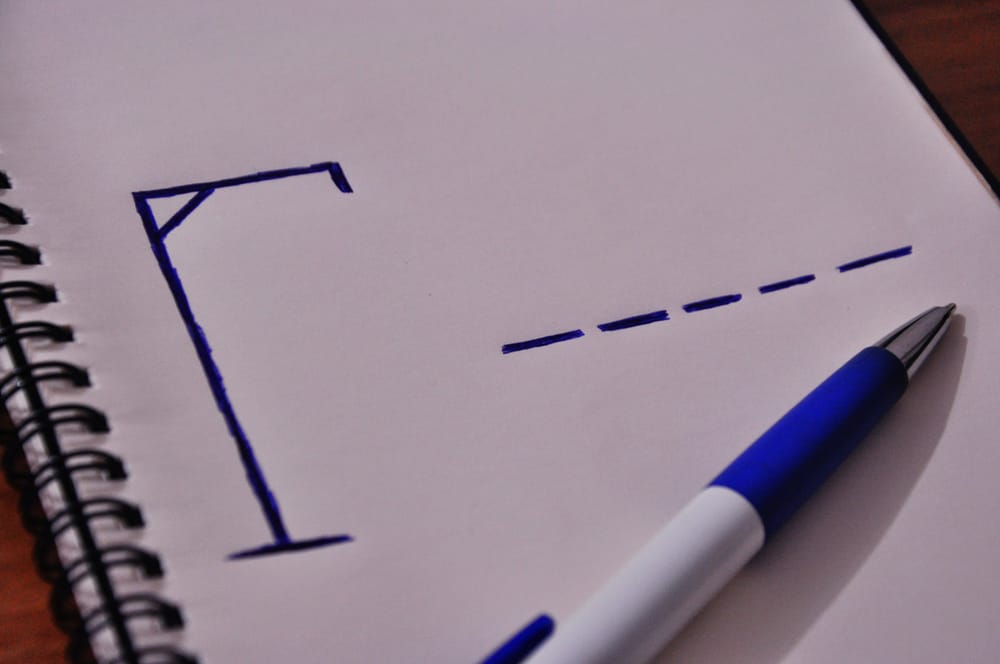 200 Best Indoor Activities for Kids 5 This is a close look at a hangman game on notebook with a pen.