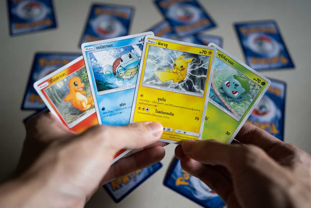 Original Pokemon cards in hand.