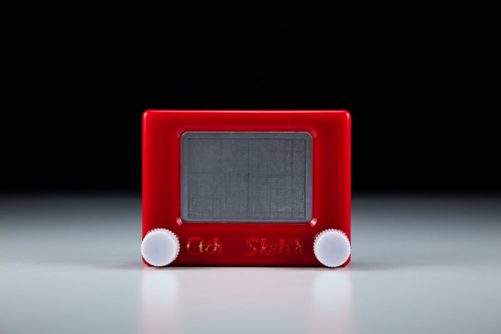 This is a vintage Etch a Sketch plastic toy.