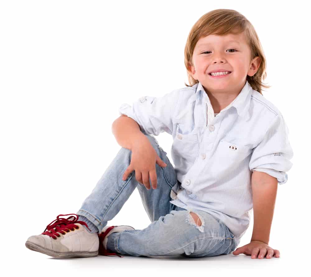17 Best Toys for 5 Year Old Boys 1 Happy little boy sitting on the floor.