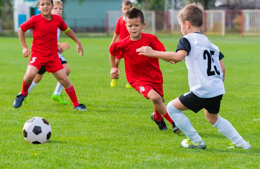 Boys playing football on the sports field.