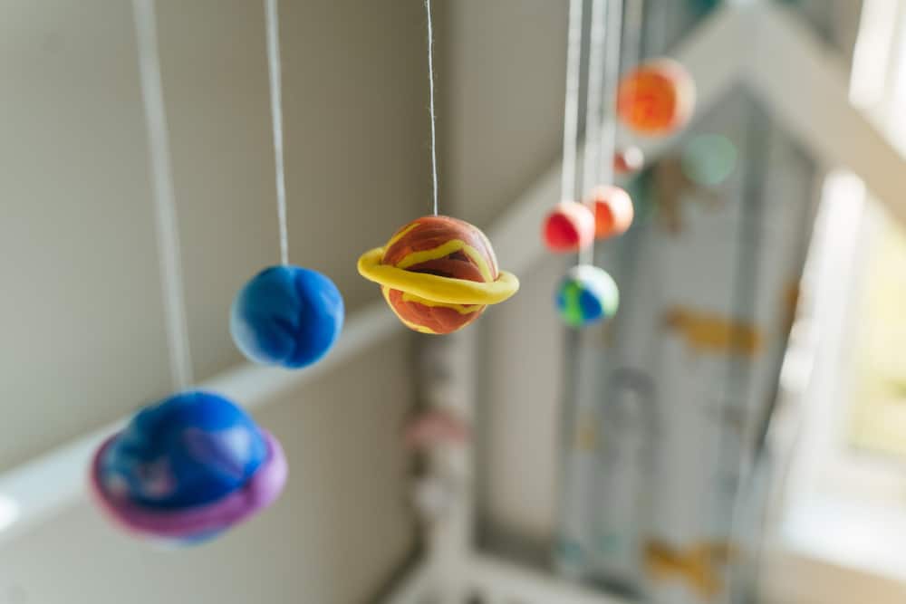 50 Best Space Activities for Kids 4 Solar system model hanging over the kid's bed.