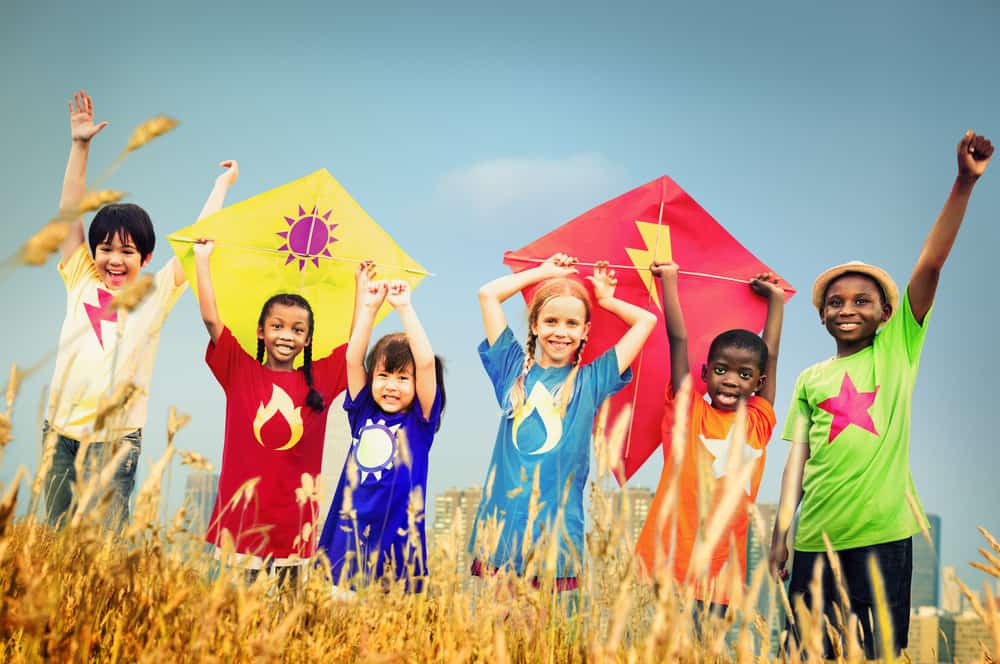 100 Best Kids Birthday Party Ideas 14 A group of children playing kites on a field.