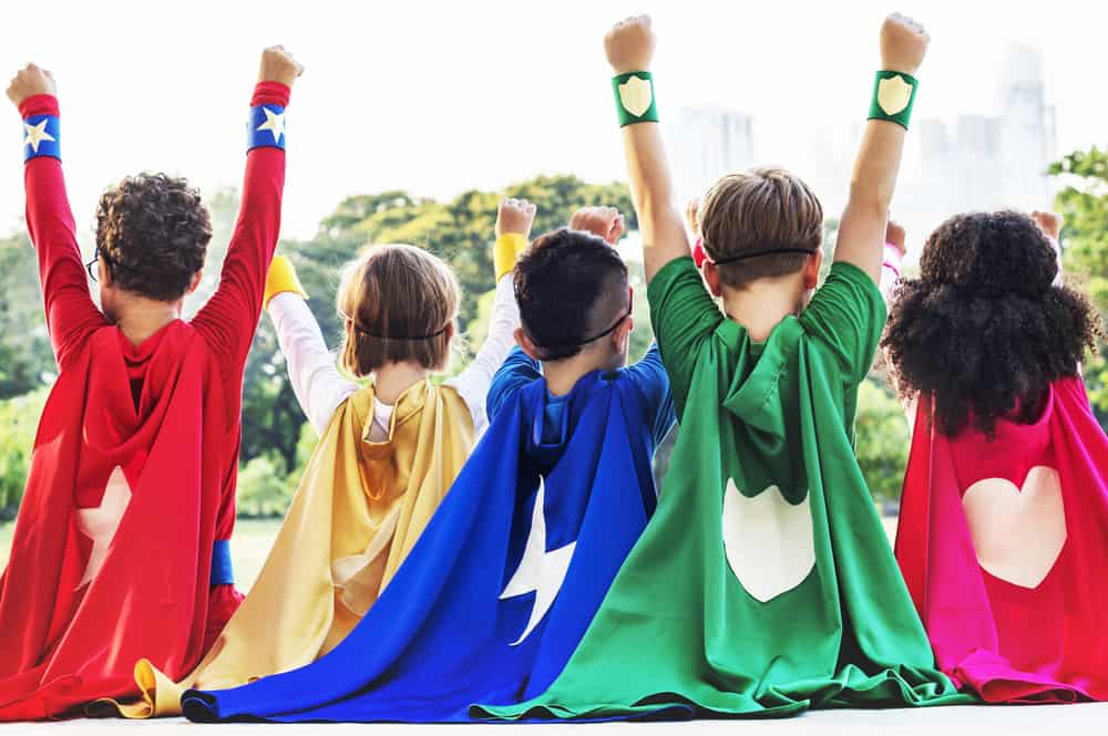100 Best Kids Birthday Party Ideas 12 Back profile of kids wearing superhero costumes.