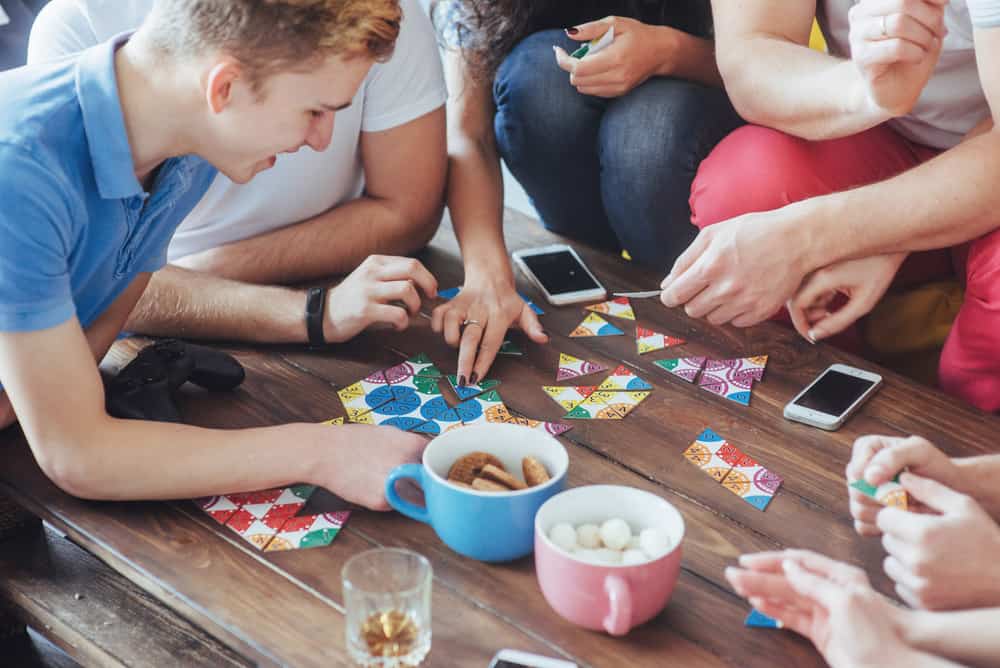 Teens playing board games at home.