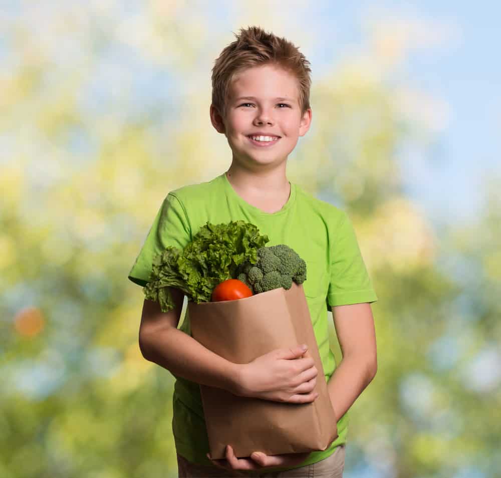 20 Best Chores for 7-9 Year Olds 16 Boy carrying a bag of groceries.