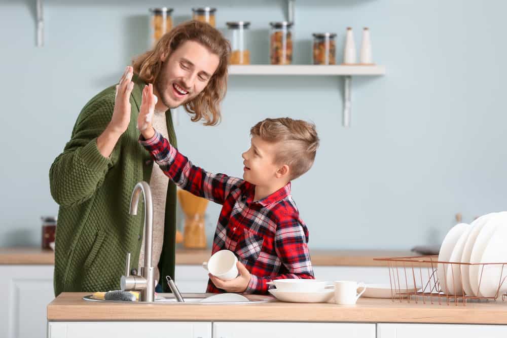9 Best Chores for 10-12 Year Olds 3 Father and son washing dishes in the kitchen.