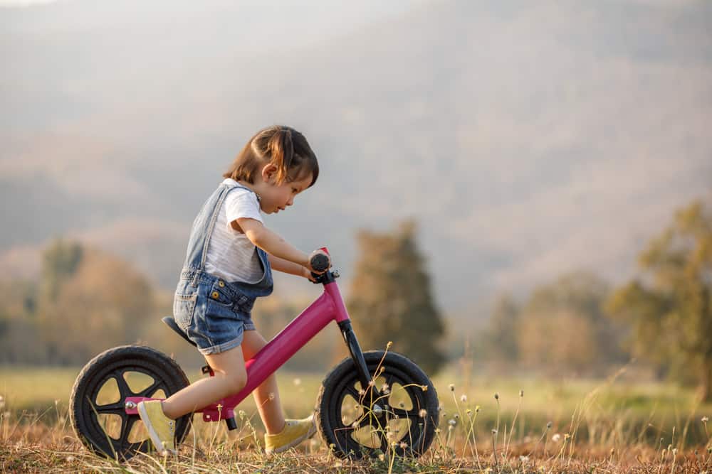 Little girl learning to bike.