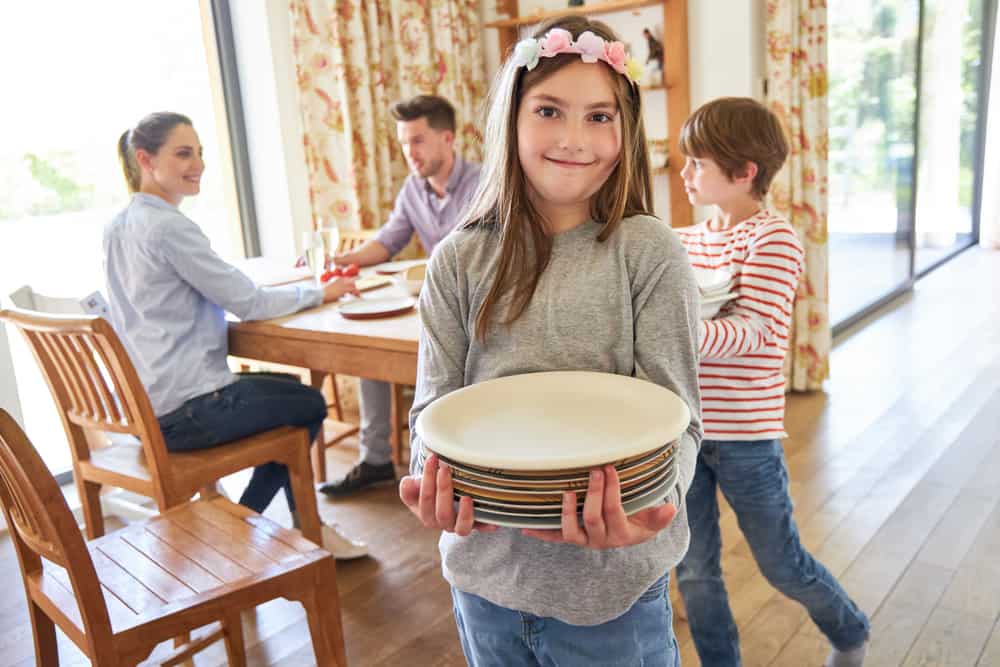 9 Best Chores for 10-12 Year Olds 4 Kids helping parents clear the dishes.