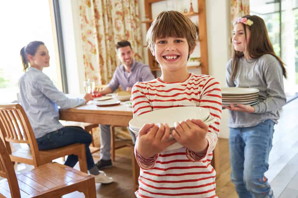 20 Best Chores for 7-9 Year Olds 15 Kids help parents clear the dishes in the table.
