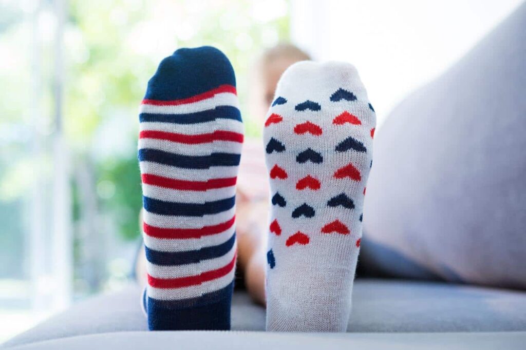 Close-up of kids socks with striped and heart pattern.