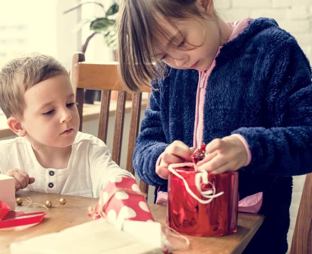 20 Best Chores for 7-9 Year Olds 17 Kids wrapping gifts on the dining table.