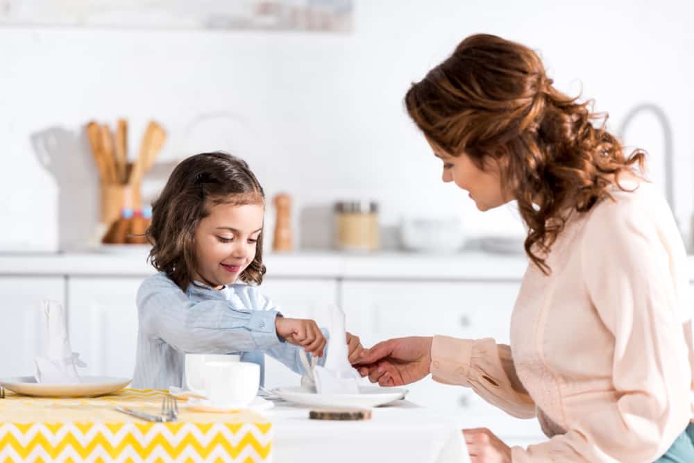 15 Best Chores for 5-6 Year Olds 11 Mother and daughter setting up the table.