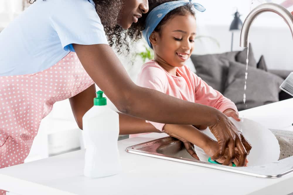 20 Best Chores for 7-9 Year Olds 8 Mother and daughter washing dishes in the kitchen.