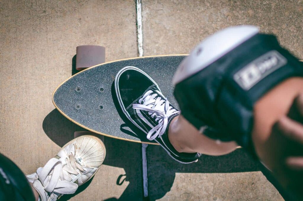 Top view of a foot resting on a skateboard.