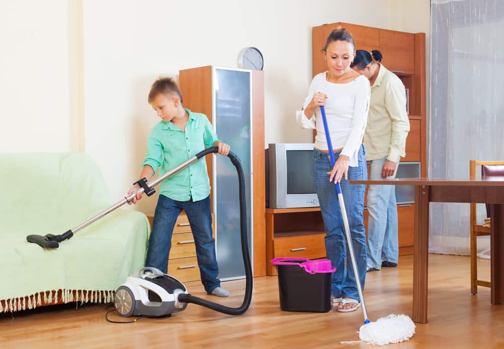 44 Best Chores for Teenagers 21 A family with teen doing house chores.