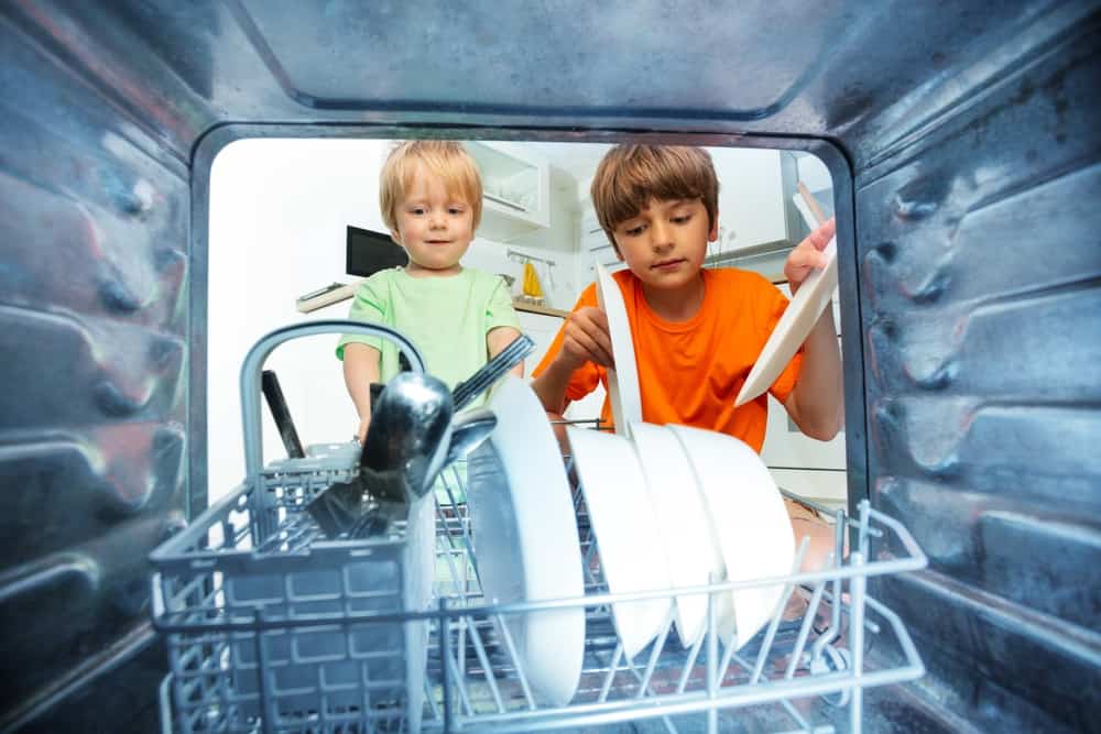 15 Best Chores for 5-6 Year Olds 4 Little boys taking out the dishes from the dishwasher.