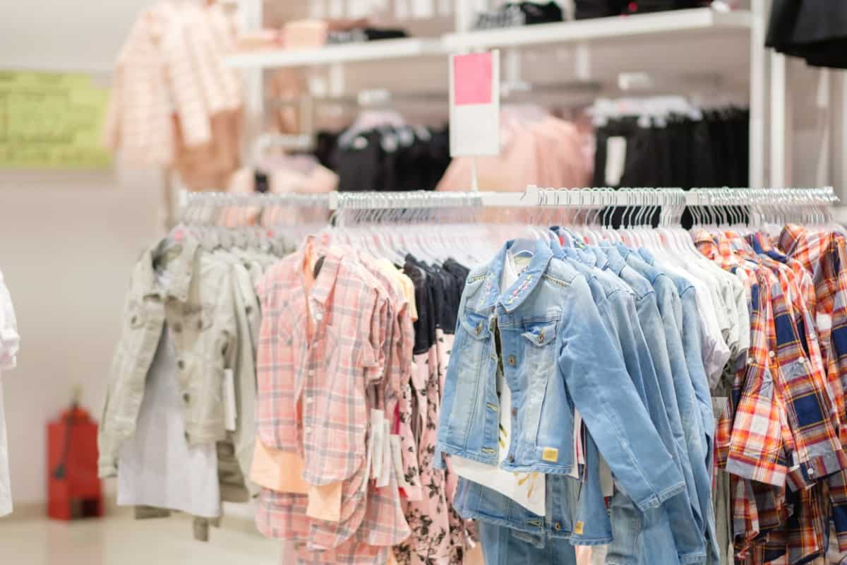A variety of children's clothes in a store.