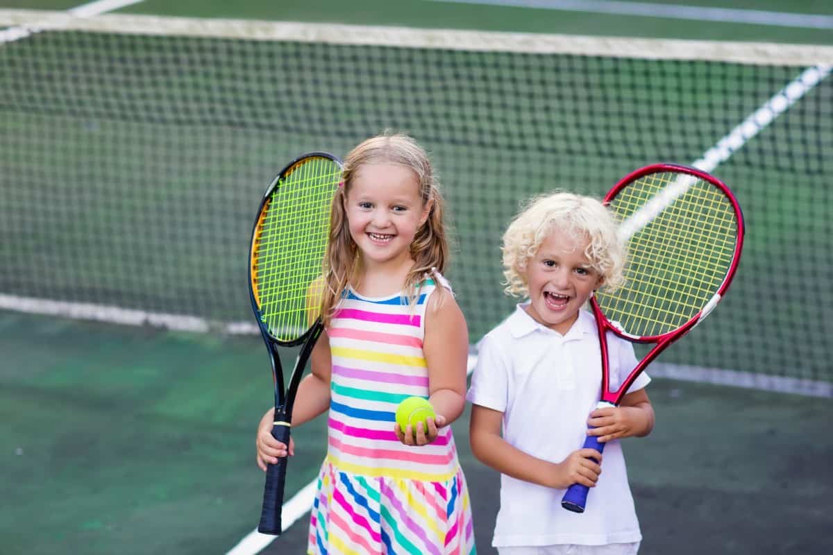 6 Popular Types of Tennis Racquets for Kids 2 Kids playing tennis in court.