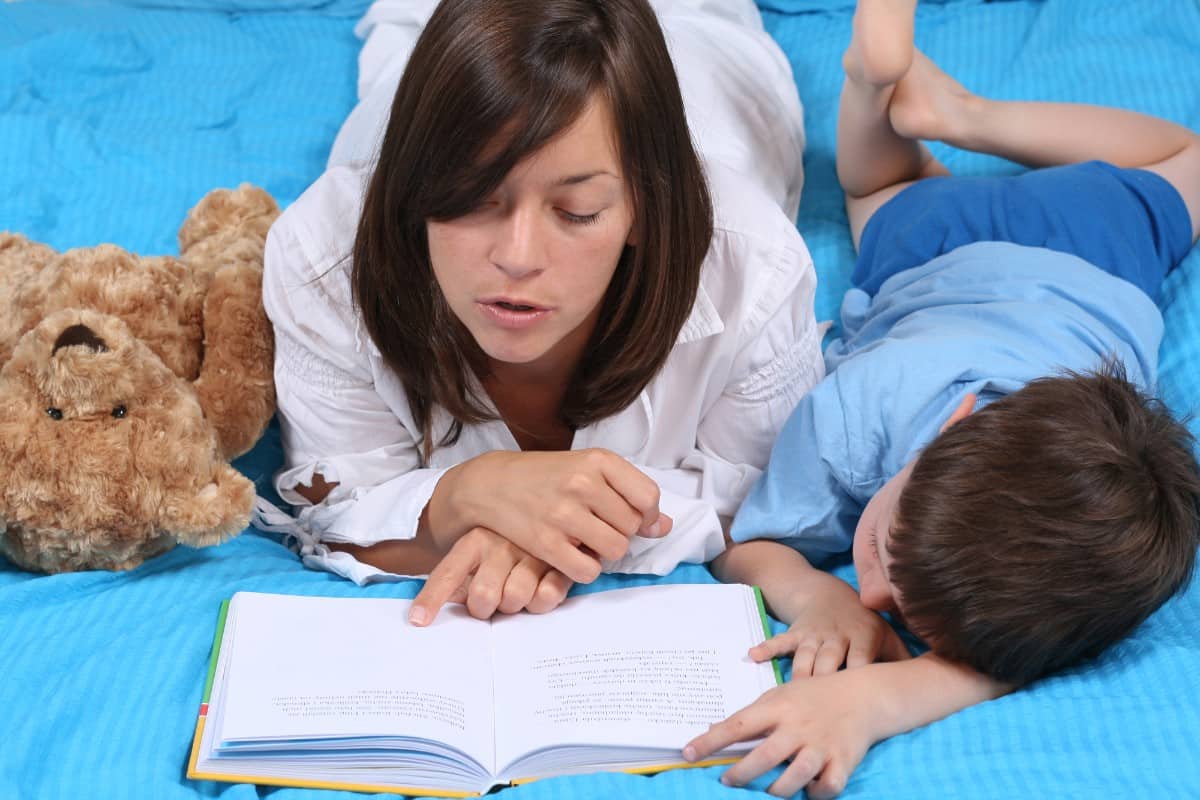 Mom and son reading a book.