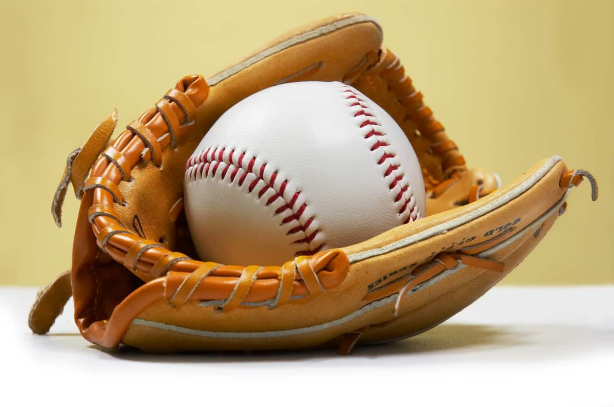 Kid's baseball glove holding a ball.