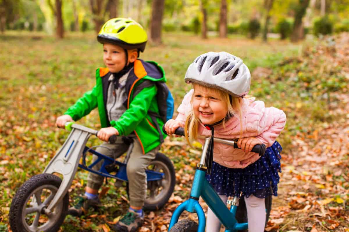 Little boy and girl riding a bike.