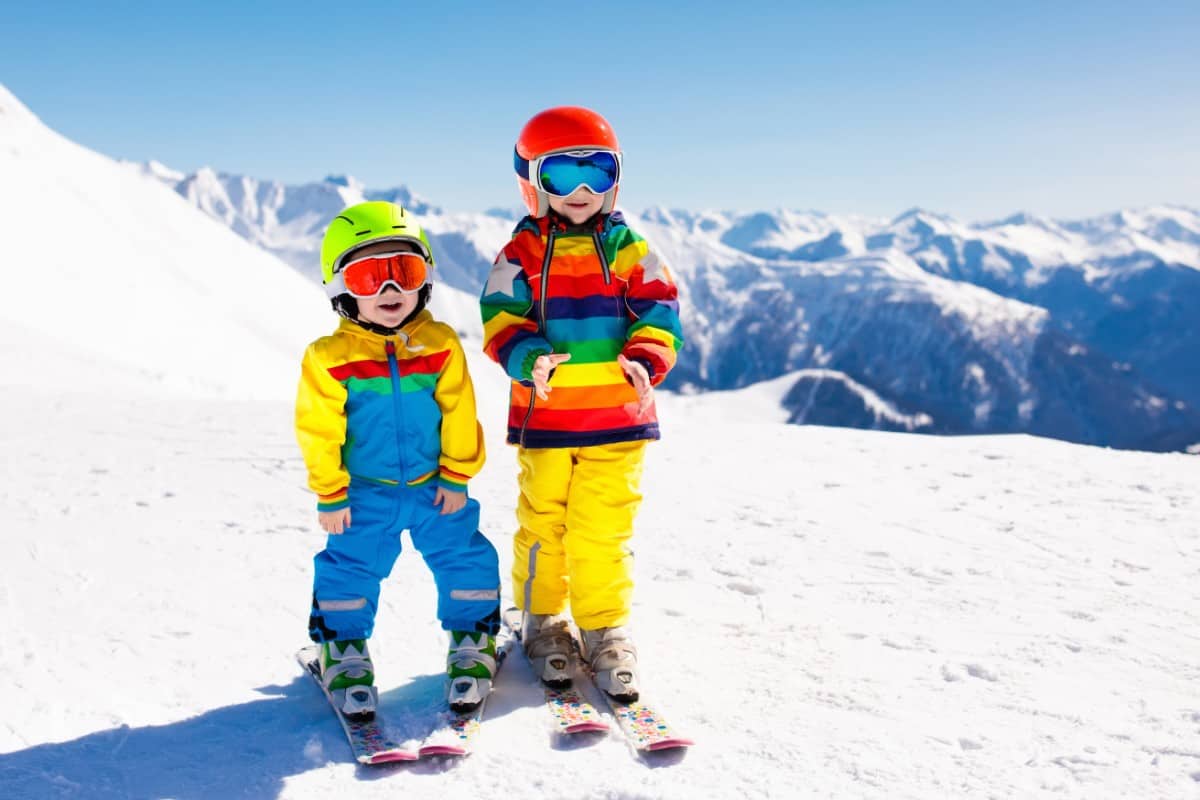 Kids skiing in the mountain.