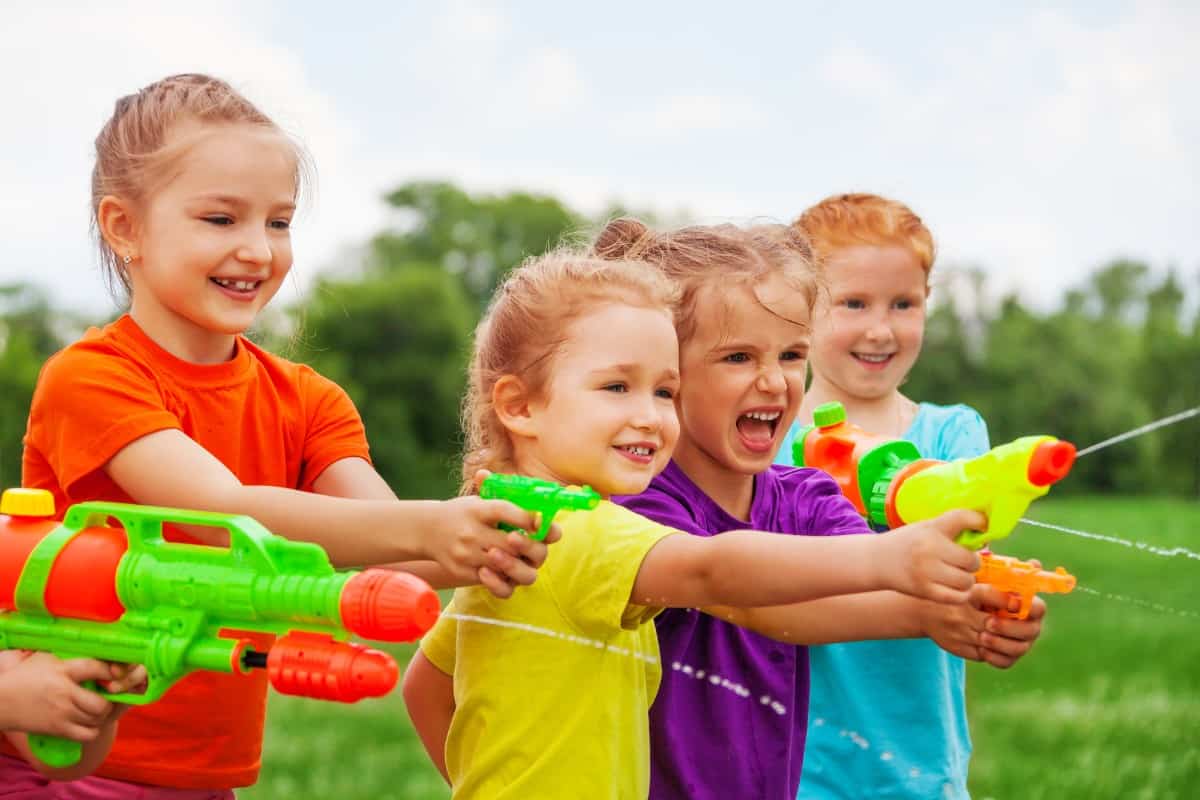 Kids playing with water guns.