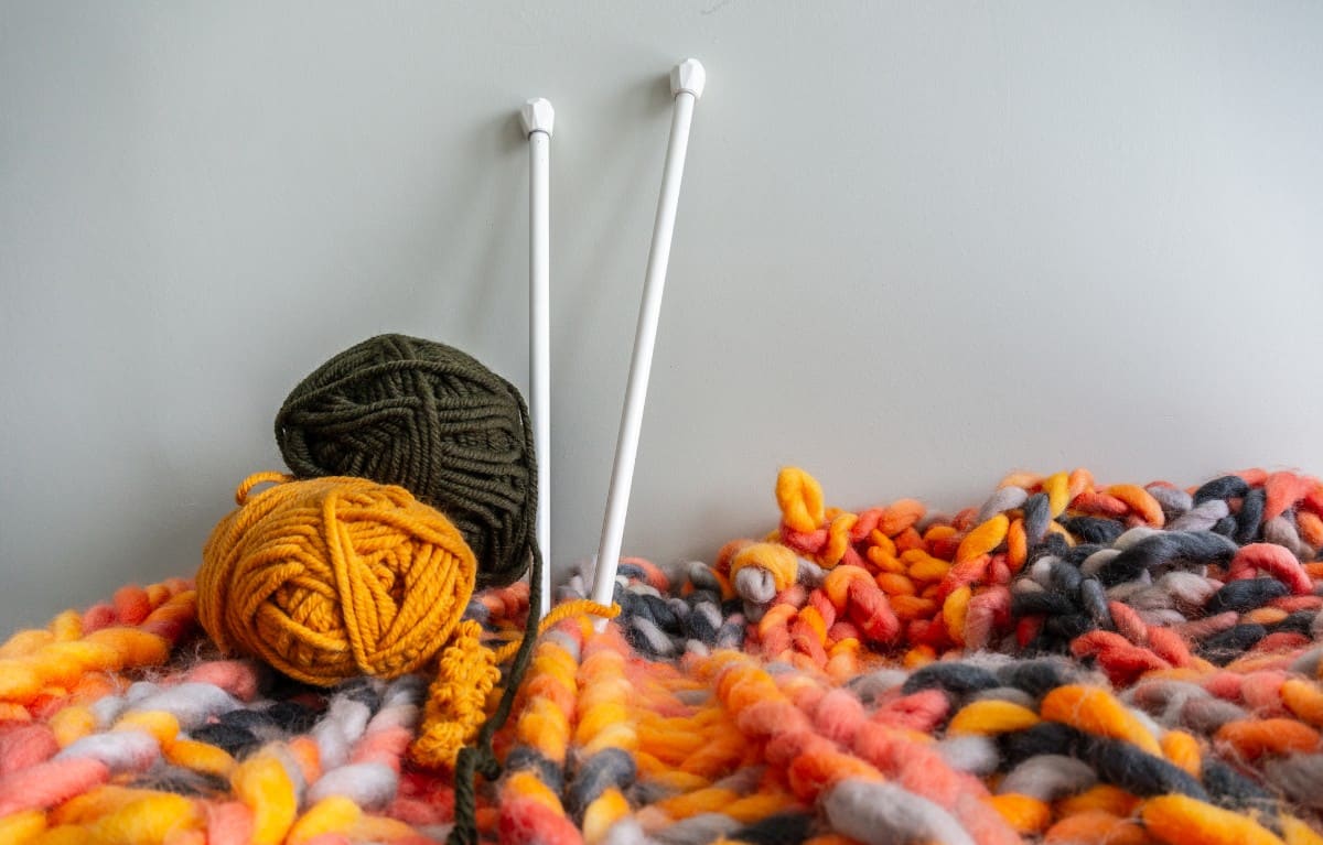 Ball of yarns and knitting needles.