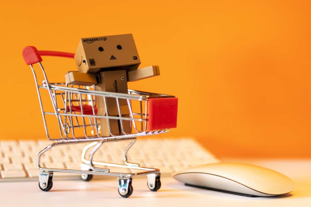 Where Can You Buy Used LEGO Sets? 6 Amazon box mascot in a shopping cart.