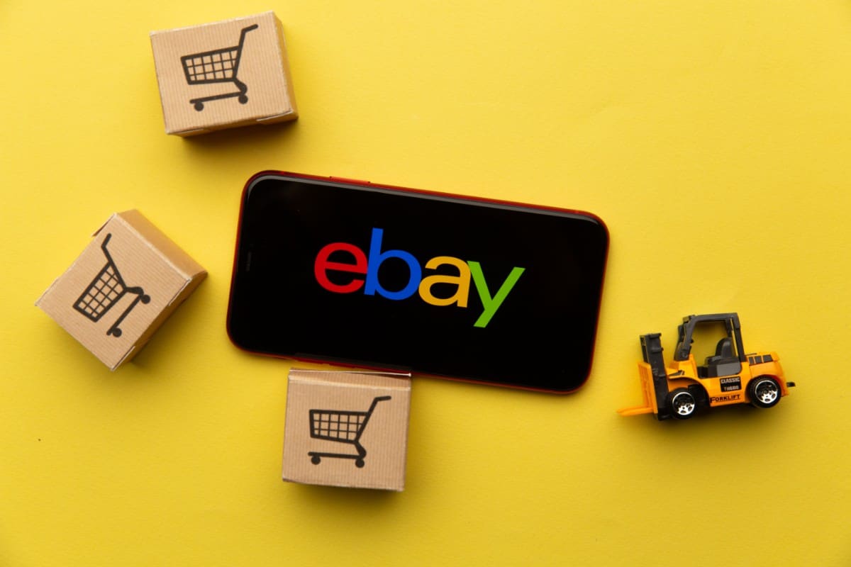 Where Can You Buy Used LEGO Sets? 3 eBay logo displayed on phone.