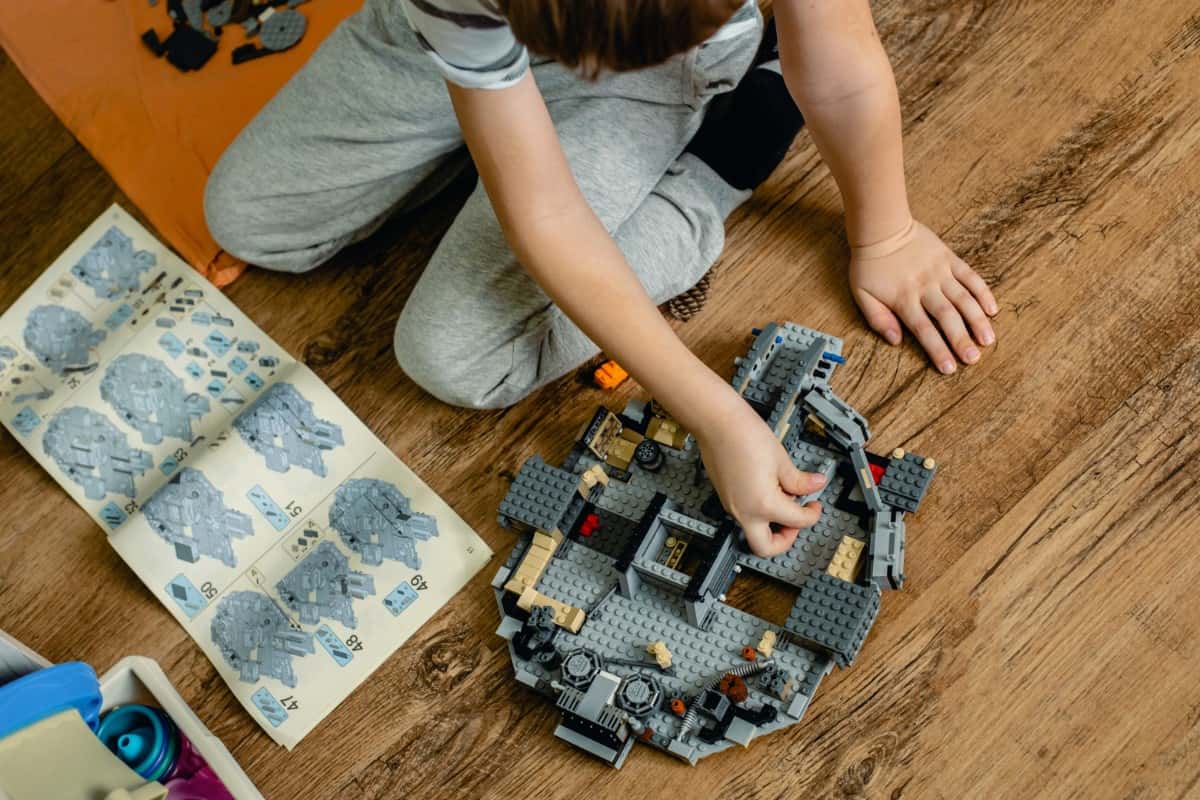 Little boy building a Lego set.
