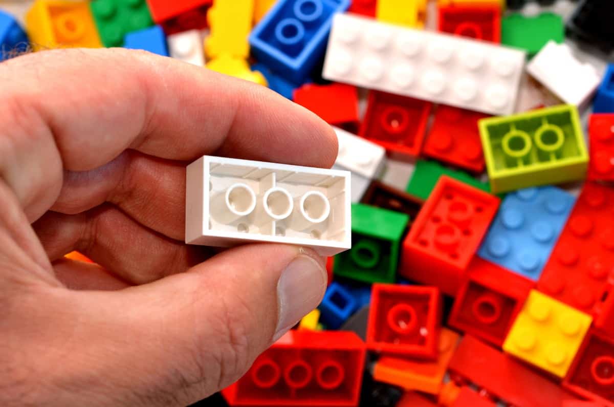 Hand holding a block of Lego.