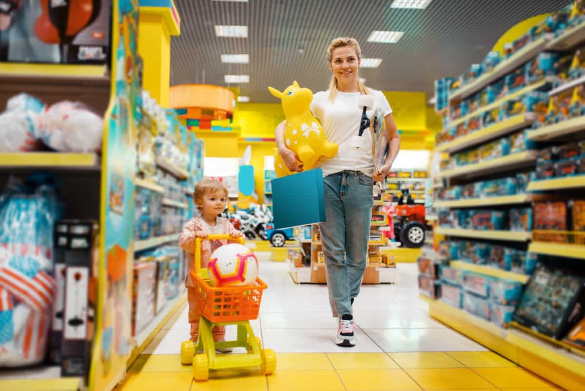 Mother and daughter buying toys in a store.