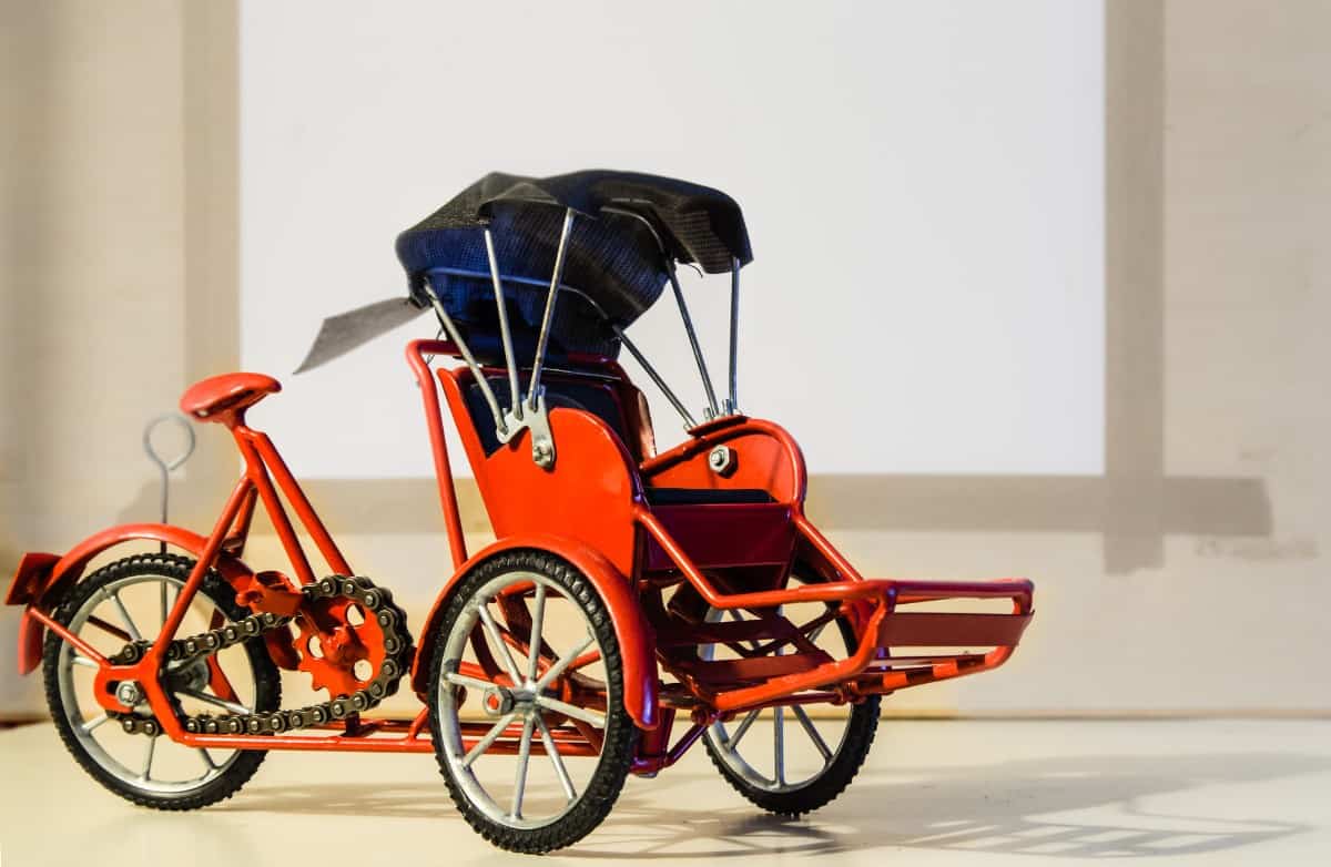 Red tricycle with canopy.