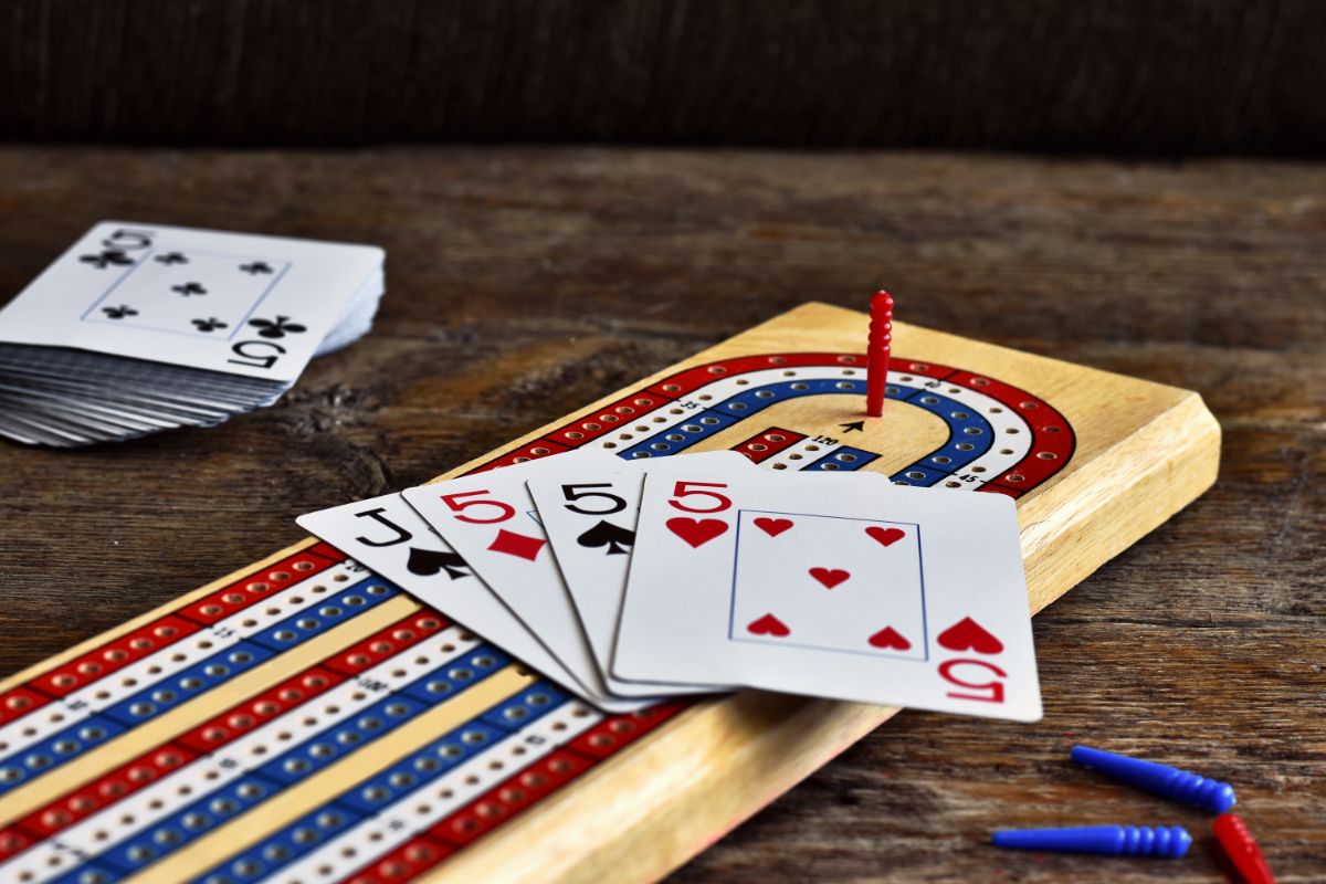 2 Player Card Games: What Card Games Can You Play With 2 People? 2 Cribbage card game and a wooden board.