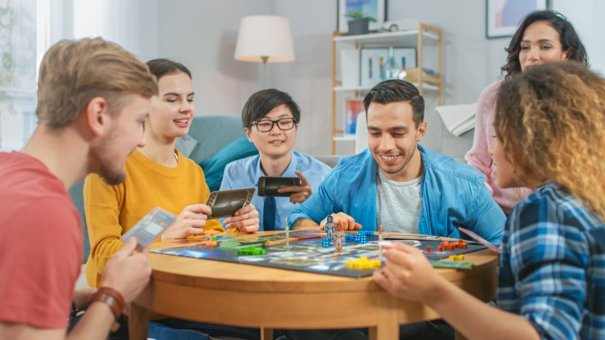 Group of teens playing card games.