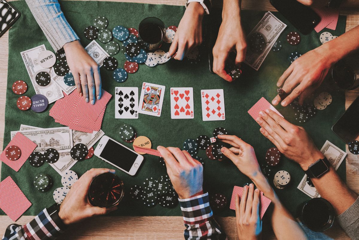 Group of people playing cards and dice.
