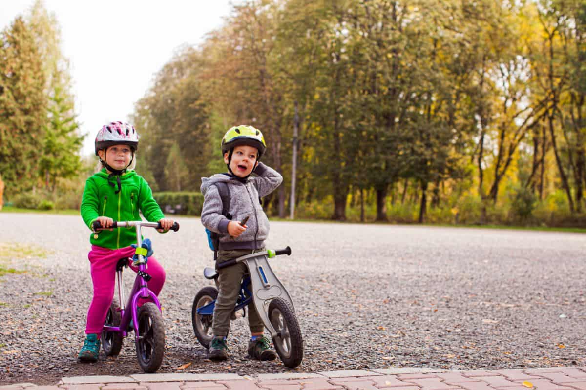 Two young books on their bikes outdoors.