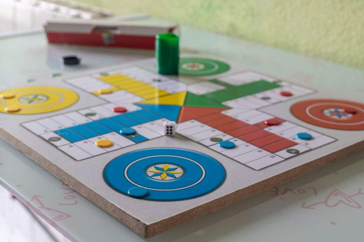 17 Amazing Board Games Similar to Sorry 2 A board game known as Parcheesi and a dice.